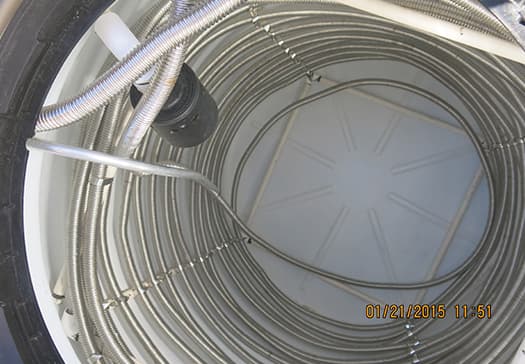 Corrugated stainless steel heat-exchanger tubing coiled inside the PVDHW storage tank