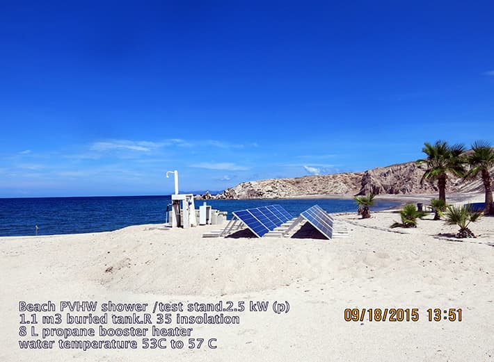 Two photovoltaic arrays powering an experimental buried-tank water heating system near a beach